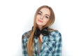 Headshot of a young adorable blonde woman in blue plaid shirt enjoying listening music to big professional dj headphones. Royalty Free Stock Photo