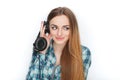 Headshot of a young adorable blonde woman in blue plaid shirt enjoying listening music to big professional dj headphones. Royalty Free Stock Photo