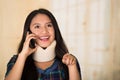 Headshot young hispanic woman posing wearing neck brace, smiling happily while talking on phone, injury concept