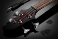 Headstock of electric bass guitar, audio cable and picks