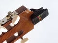 Headstock of the guitar with installed clip-on tuner, that shows