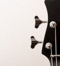 Headstock of the guitar. The pegs and strings of a bass guitar close-up. Musical instrument. Black glossy paint Royalty Free Stock Photo