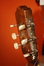 Headstock with mechanics of a classical guitar with orange background