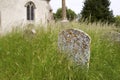 Headstone in Overgrown Church Yard Royalty Free Stock Photo