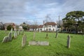 Headstones in a Churchyard with the Village Pub in the background