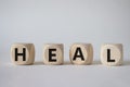 Heal symbol. Concept word Hate on wooden cubes. Beautiful white background. Healthcare and Heal concept. Copy space