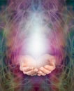 Healer's cupped hands and energy manifestation