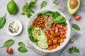 healhty vegan lunch bowl. Avocado, quinoa, sweet potato, tomato, spinach and chickpeas vegetables salad