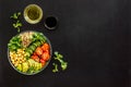 Healthy vegan lunch bowl. Avocado, quinoa, sweet potato, tomato, spinach and chickpeas vegetables salad on black table Royalty Free Stock Photo