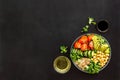 Healhty vegan lunch bowl. Avocado, quinoa, sweet potato, tomato, spinach and chickpeas vegetables salad on black table Royalty Free Stock Photo