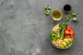 Healhty vegan lunch bowl. Avocado, quinoa, sweet potato, tomato, spinach and chickpeas vegetables salad on gray table Royalty Free Stock Photo