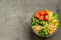 Healhty vegan lunch bowl. Avocado, quinoa, sweet potato, tomato, spinach and chickpeas vegetables salad on gray table Royalty Free Stock Photo