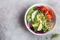 Healhty vegan lunch bowl. Avocado, quinoa, tomato, cucumber, red