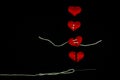 Healing broken heart concept red heart is sewn with white thread with needle on black background