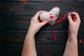 Healing broken heart. Hands sewing a fabric heart with a needle Royalty Free Stock Photo