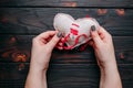 Healing broken heart. Hands sewing a fabric heart with a needle Royalty Free Stock Photo