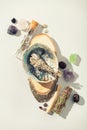 Healing crystals, palo santo, white sage bundle on abalone sea shell, dry healing herbs on white background Royalty Free Stock Photo