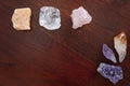 Healing crystals: Rose quartz, Calcite, citrine, amethyst and a Clear quartz on a table. Gemstones are used for their positive Royalty Free Stock Photo