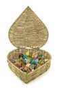 Healing crystals stored in heart shaped basket Royalty Free Stock Photo