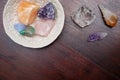 Healing crystals on a wooden table in a bowl, including: Clear Quartz, Citrine, agate, aventurine, calcite, amethyst and rose Royalty Free Stock Photo