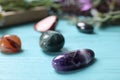 Healing gemstones on light blue wooden table