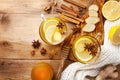 Healing ginger tea in two glass mug in scarf with lemon, honey and spices. Autumn hot drink on rustic wooden table top view Royalty Free Stock Photo