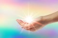 Healing hands with bright sunburst on rainbow background Royalty Free Stock Photo