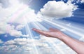 Healing hands in the sky with bright sunburst. Royalty Free Stock Photo