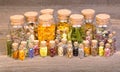 Healing herbs in bottles for herbal medicine on old wooden table Royalty Free Stock Photo