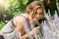 The healing power of lavender. A young woman smelling lavender in her garden. Royalty Free Stock Photo