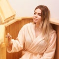 Healing spa treatment in cedar barrel. Young beautiful girl do salon procedure. Health accessories Royalty Free Stock Photo
