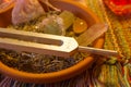 Healing tuning fork and crystal stone on table . Royalty Free Stock Photo