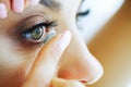 Health. Beautiful Young Girl Holds On A Finger Contact Lens. Portrait of a Beautiful Woman with Green Eyes. Healthy Look Royalty Free Stock Photo