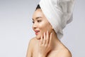 Health and beauty concept - Attractive asian woman applying cream on her skin, on white. Royalty Free Stock Photo