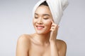 Health and beauty concept - Attractive asian woman applying cream on her skin, on white. Royalty Free Stock Photo