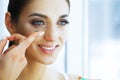 Health and Beauty. Young Woman Applying Contact Lenses. Fresh View. Portrait of a Beautiful Woman with Green Contact Royalty Free Stock Photo