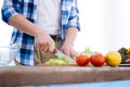 Young male hands slicing salad