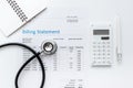 Health care billing statement with doctor`s stethoscope on white background top view mock-up