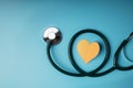 Health Care Concept. International World Heart Day. Paper Cut as Heart Shape with Stethoscope lay on Blue background