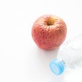 Health care concept with spoiled apple and bottle of water Royalty Free Stock Photo