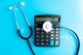 Health care costs. Stethoscope and calculator symbol for health care costs or medical insurance Royalty Free Stock Photo