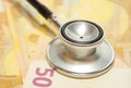 Health care costs - Stethoscope on money backgroun