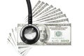 Health care costs. Stethoscope and money symbol for health care Royalty Free Stock Photo