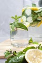 Health care, fitness, healthy food concept. Fresh cool mint lemon cucumber pour water, cocktail, detox drink, lemonade in a glass Royalty Free Stock Photo