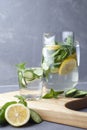 Health care, fitness, healthy food concept. Fresh cool mint lemon cucumber pour water, cocktail, detox drink, lemonade in a glass Royalty Free Stock Photo