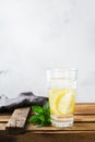 Glass of fresh cool lemon infused water detox drink