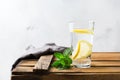 Glass of fresh cool lemon infused water detox drink