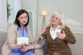 Experienced female caregiver monitoring elder woman health