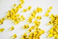 Health care and immunity support concept. Vitamin D3 softgel capsules on a white surface. Yellow softgels, top view