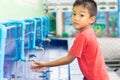 Health care and kid concept. Asian child boy washing his hands before eating food and after play the toys at the washing bowl.